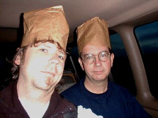 Paul and Tom show resourcefulness in their use of paper bags as hats.