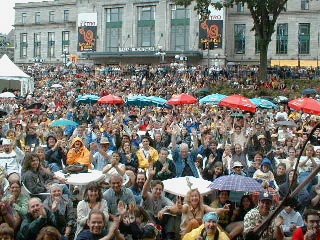 Umbrellas open, as the crowd fears the worst...