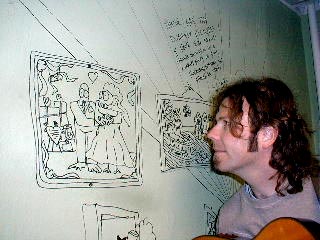 Paul checks out the wall of graffiti.